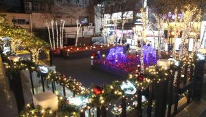 a city street decorated with christmas lights and trees at Hotel Skypark Central Myeongdong in Seoul