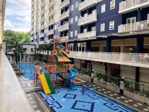 a playground in front of a apartment building at Fastrooms Bekasi in Bekasi