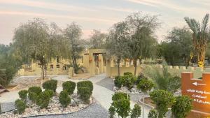 a rendering of a garden in front of a building at Al Bait resort with private swimming pools -HRS stables in Al Ḩamrānīyah