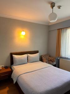 a bedroom with a large bed with white sheets at Lonca Butik Hotel in Giresun