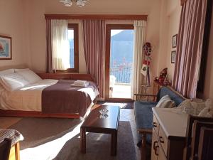 a bedroom with a bed and a living room at LOUNA in Metsovo