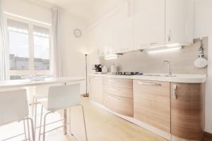 a kitchen with white cabinets and a sink and a counter at Stellamaris, Stile Marino e Relax a Viareggio in Viareggio