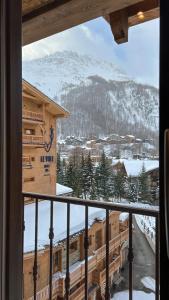 a view of a mountain from a window with a train at RESIDENCE GRAND COCOR -Studio 25 m2- in Val-d'Isère