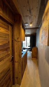 a room with wooden walls and a hallway with a door at RESIDENCE GRAND COCOR -Studio 25 m2- in Val-d'Isère