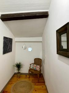 a living room with a chair and a window at Maison au coeur de la Dombes in Le Plantay