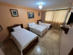 Letto o letti in una camera di Hotel Bucaneiro