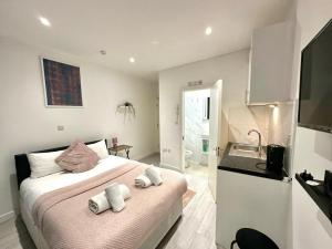 a bedroom with a bed with towels on it at Kent House Suites - SE26 in Forest Hill