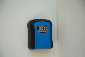a blue and black soap dispenser on a wall at CasaPEDROCasaMarcio - Soure, Marajó PA in Soure
