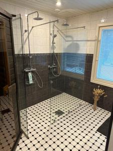 a shower with a glass door in a bathroom at Villa Lilla in Porvoo
