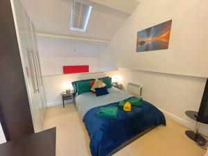 a bedroom with a large blue bed in a room at Vibrant Loft Apartment in Grade II Listed Georgian Building in Sheffield