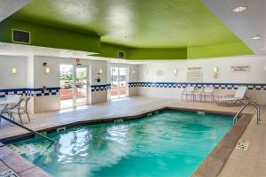 a swimming pool with a green ceiling at Fairfield Inn and Suites by Marriott Indianapolis/ Noblesville in Noblesville