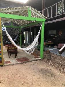 a hammock on the patio of a house at Las Alquimillas apart -a 70 metros de la playa- in Punta Del Diablo
