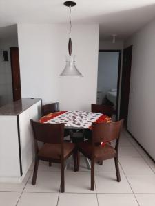 a dining room table and chairs in a kitchen at Apto 2Q Atlantic Ocean Beira Mar in Fortaleza