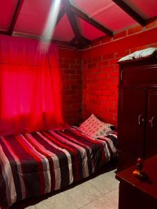 聖羅莎德卡瓦爾的住宿－finca en guacas，红色的房间,配有一张红色窗帘的床