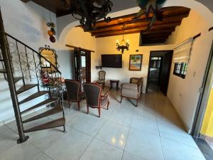 a living room with a staircase and a table and chairs at El Mortiño in San Gil