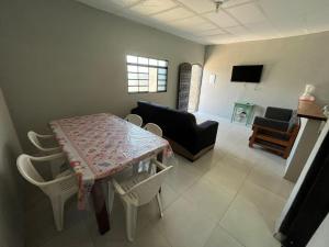 een woonkamer met een tafel en een bank bij 200m da Praia, Piscina Itanhaém in Itanhaém