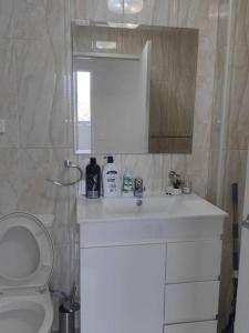 a bathroom with a white sink and a toilet at Entire home in Liverpool in Liverpool