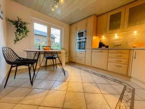 a kitchen with a table and two chairs in it at Charmantes LandRefugium Eifel in Kall