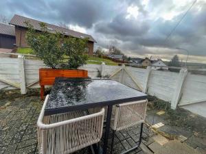 a table with a plant on top of a fence at Charmantes LandRefugium Eifel in Kall