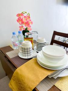 a table with plates and dishes on top of it at The Loop North Tower in Cagayan de Oro