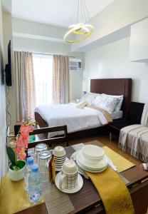 a living room with a table and a bed at The Loop North Tower in Cagayan de Oro