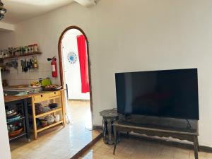 a living room with a large flat screen tv on a wall at Chez Yahia, Au coeur de L'Ourika in Ourika