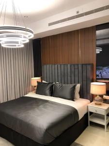 Un dormitorio con una cama grande y una lámpara de araña. en Dana Hotel, en Buraidah