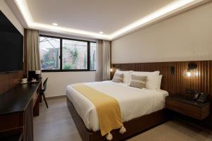 a bedroom with a large bed and a window at Origen 438 Luxury Boutique Hotel in Guadalajara
