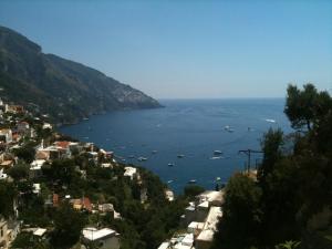 a view of a city with boats in the water at Hotel Posa Posa in Positano