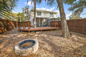 a backyard with a fire pit and a house at The Augustine - Steps to Downtown w King Bed in Mount Dora