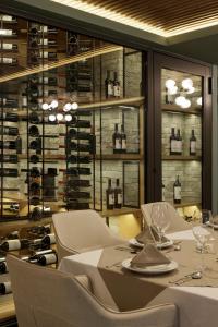 a dining room with a table and chairs and wine racks at Origen 438 Luxury Boutique Hotel in Guadalajara