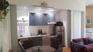 a kitchen with a table and a kitchen with a refrigerator at L'appart d'à coté 1 chambre in Sarlat-la-Canéda +26 photos