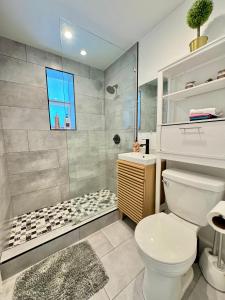 a bathroom with a white toilet and a shower at HOT TUB HOUSE ON GOLF COURSE! 10 MINs TO THE BEACH in Miami