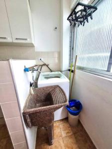 a bathroom with a sink in the corner of a room at Apartamento para alugar in Mongaguá