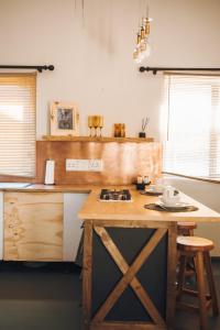 a kitchen with a wooden island with a counter top at Industrial farm stay in Polokwane in Eerstegoud
