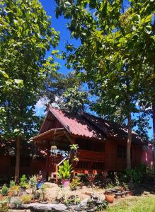 a small red house with a red roof at ปายสามหมอก in Pai