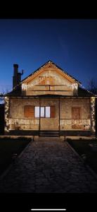 a building with lights on the front of it at The Village House in Korçë