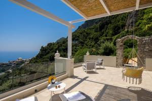 a patio with a view of the ocean at L'Acquolella in Positano