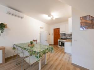 a kitchen with a table with chairs and a counter top at B&B La Ringhiera - Meda 43 in Milan