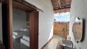 a room with a bedroom with a bed and a window at Casa Bocore in Barichara