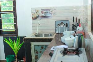 a kitchen with a sink and a counter top at Bandara House in Midigama East