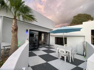 a house with a checkered floor and a palm tree at Paraiso villas in Playa Paraiso