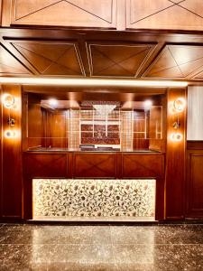 a kitchen with wooden cabinets and a counter top at Walisons Hotel in Srinagar