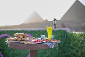 a tray of food on a table with a drink at pyramids light show in Cairo