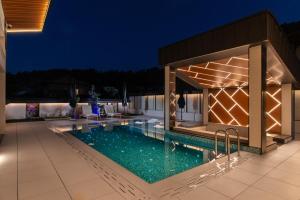 a swimming pool in a house at night at Alpine Bell Villa in Banya