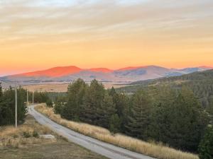 a road in the mountains at sunset at Rustic Cabin Zlatibor in Ribnica