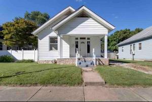 a white house with a porch and a driveway at Abode à la Mode / Centrally Located 2BR/1BA Home in Evansville