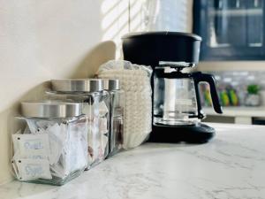 a counter top with a coffee maker and a blender at Abode à la Mode / Centrally Located 2BR/1BA Home in Evansville +17 photos