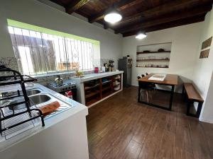 a kitchen with a sink and a table in it at Casa San Lorenzo in Huánuco
