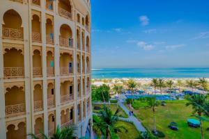 a view of a building and the beach at Beautiful Al Marjan sea view Apartment in Ras al Khaimah